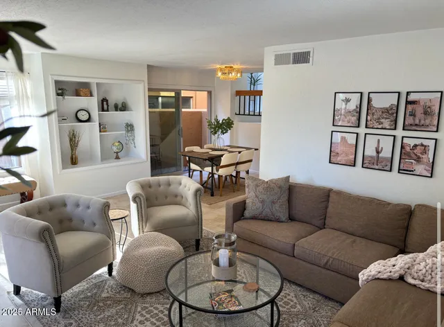 a living room with furniture a rug and a window