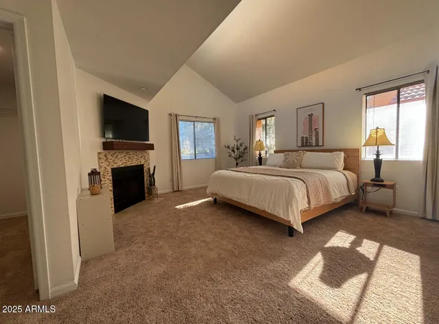 a bedroom with a bed and a flat screen tv