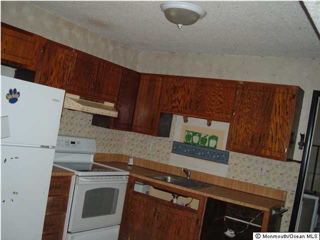 39 Anchor Road Barnegat, NJ 08005 - Photo 2 of 3 a kitchen with a stove and a microwave