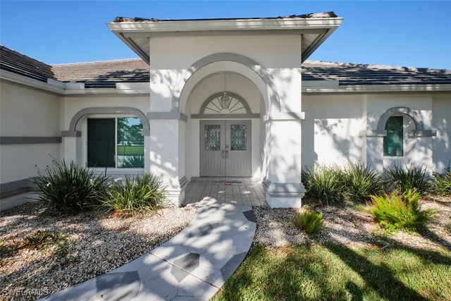 a front view of a house with garden