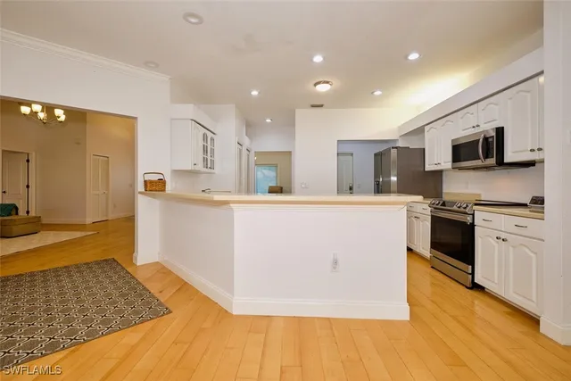 a kitchen with stainless steel appliances white cabinets and a stove