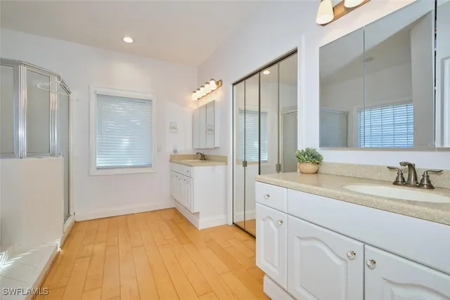 a bathroom with a tub shower and a sink