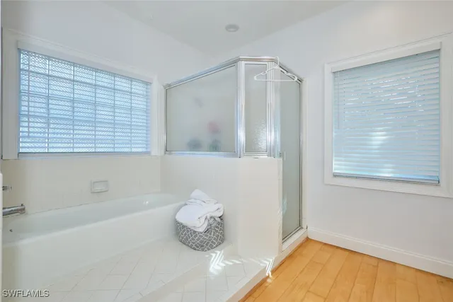 a bath room with a bath tub and a shower