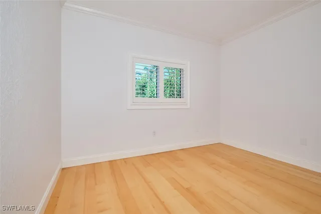 a bathroom with a granite countertop toilet a sink a mirror and a window