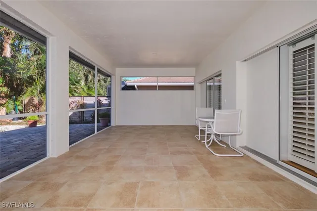 a view of porch with a floor to ceiling window and wooden floor