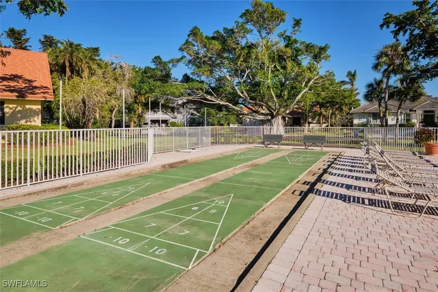 a view of a swimming pool with outdoor seating and plants