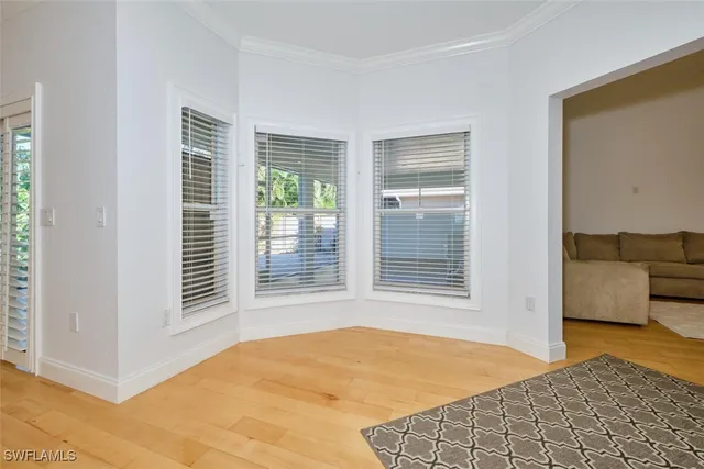 a view of an empty room with a fireplace and a large window