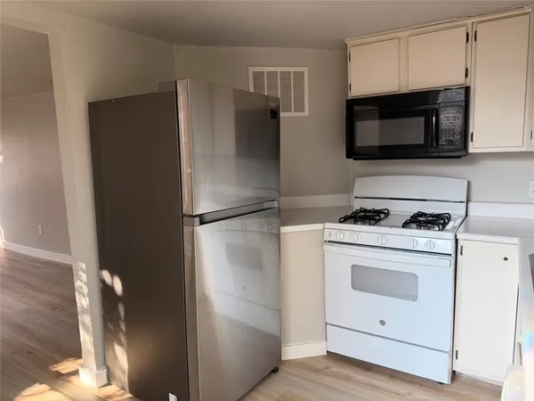 a kitchen with a refrigerator stove and microwave
