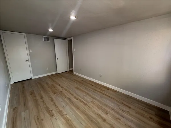 a view of room with wooden floor