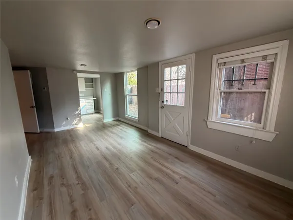 wooden floor in an empty room with a window