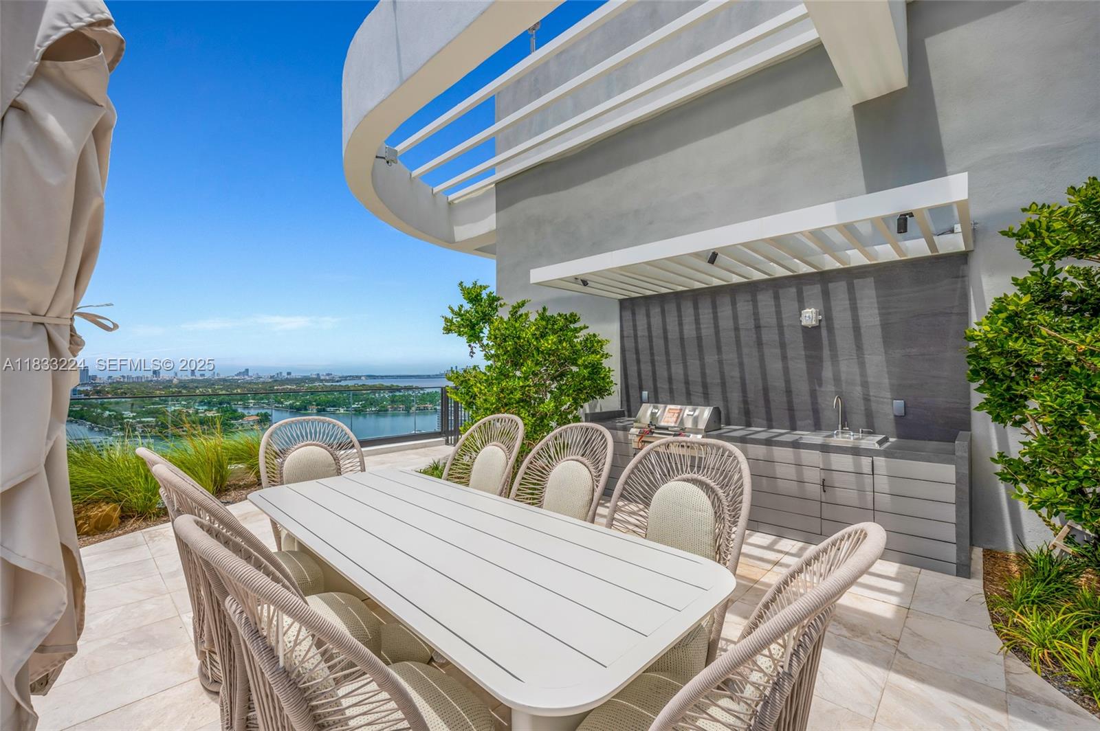 580 72nd Street, Unit 910 Miami Beach, FL 33141 - Photo 7 of 60 a view of balcony with two chairs and a potted plant