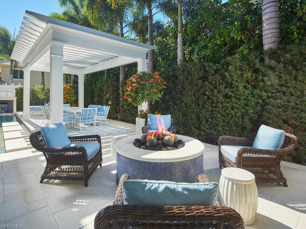 167 4th Street North Naples, FL 34102 - Photo 21 of 33 a patio with a table and chairs