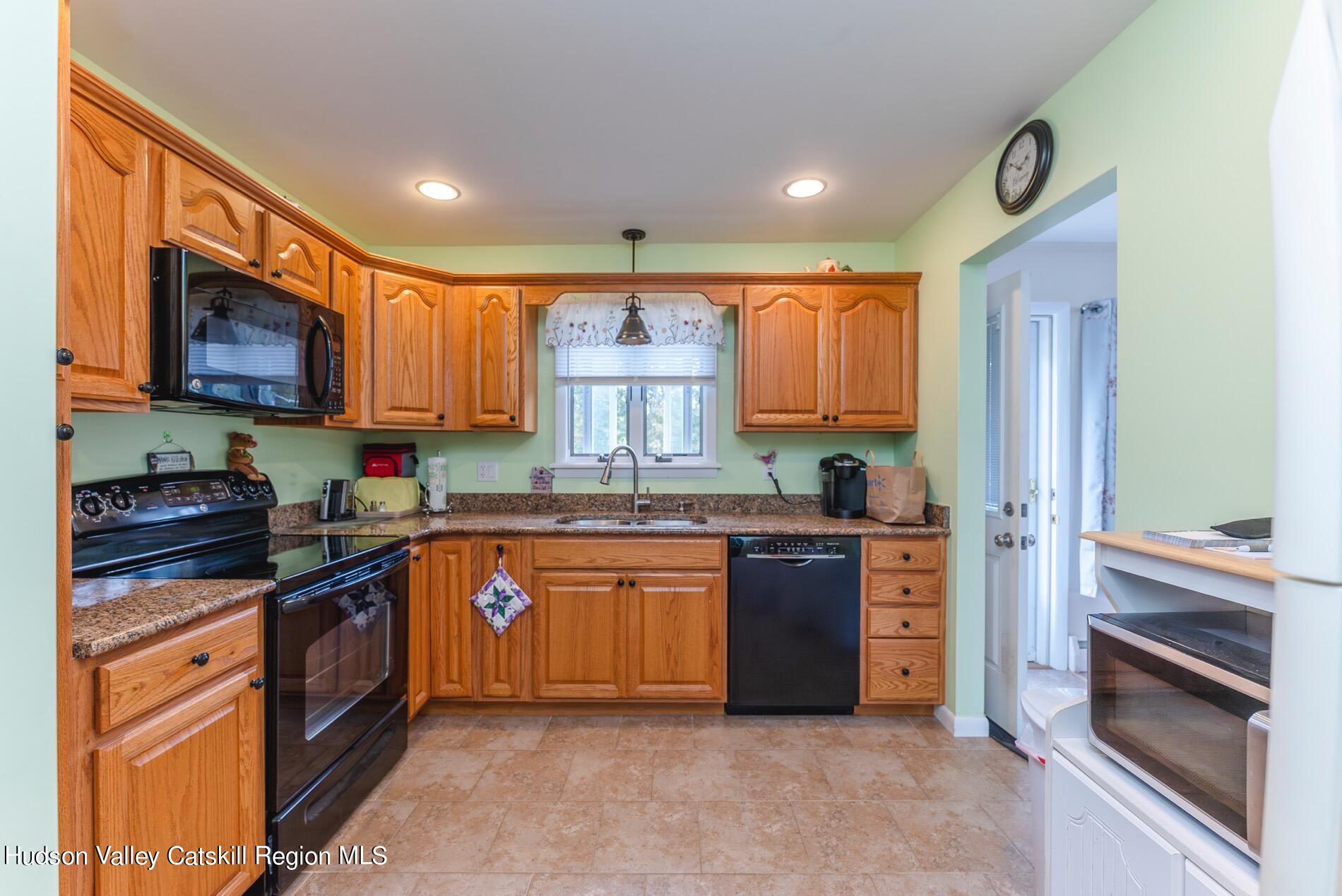 545 Mountain View Avenue Hurley, NY 12443 - Photo 12 of 31 a kitchen with stainless steel appliances granite countertop a refrigerator and a stove top oven