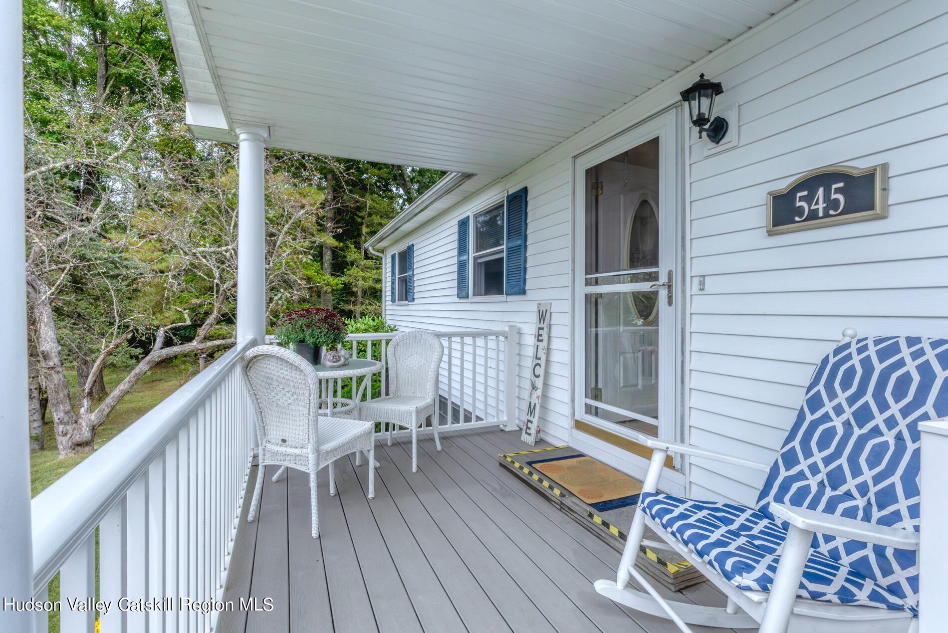 545 Mountain View Avenue Hurley, NY 12443 - Photo 3 of 31 a balcony with wooden floor table and chairs
