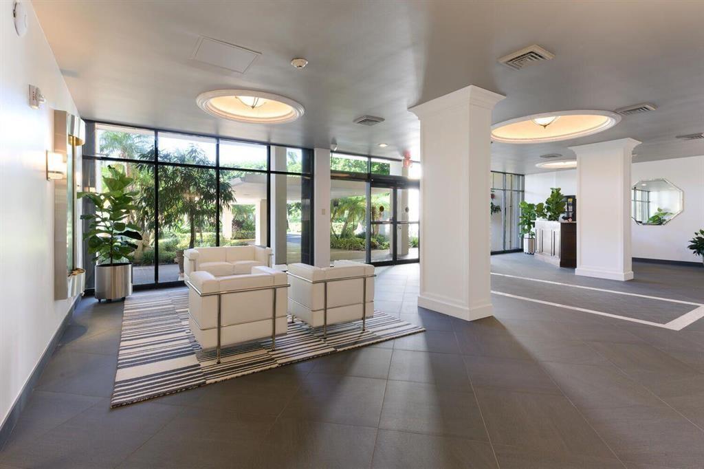 2400 Presidential Way, Unit 502 West Palm Beach, FL 33401 - Photo 20 of 28 a living room with furniture and a large window