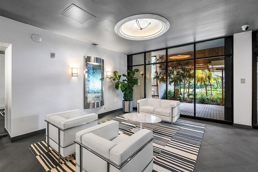 2400 Presidential Way, Unit 502 West Palm Beach, FL 33401 - Photo 22 of 28 a living room with furniture and a large window