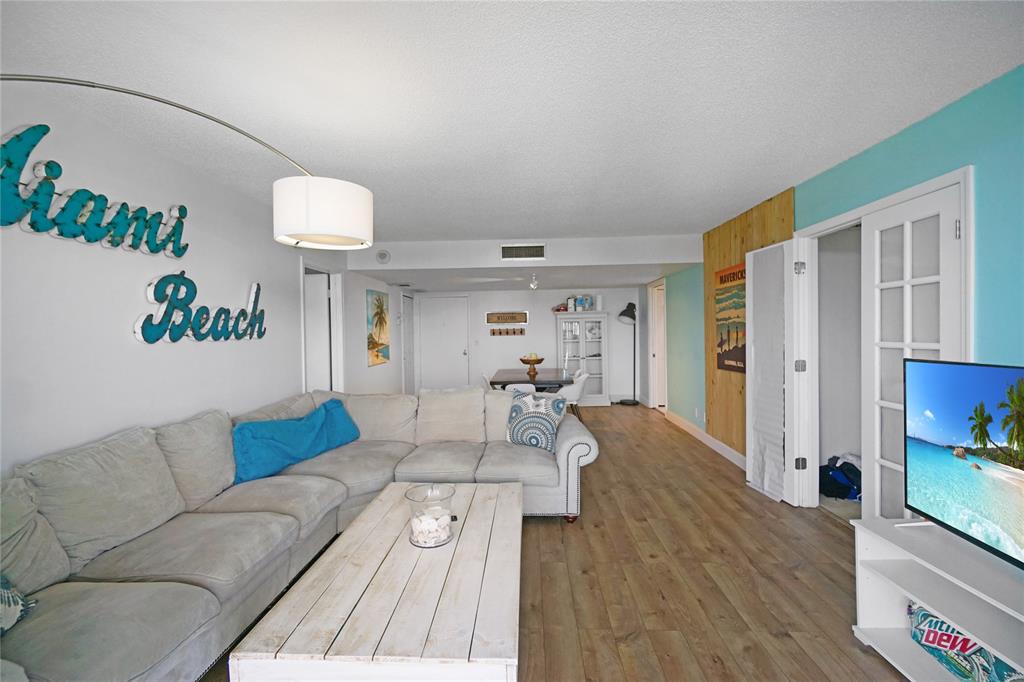 2400 Presidential Way, Unit 502 West Palm Beach, FL 33401 - Photo 4 of 28 a living room with furniture and a wooden floor