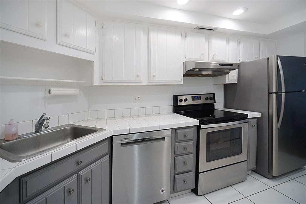 2400 Presidential Way, Unit 502 West Palm Beach, FL 33401 - Photo 6 of 28 a kitchen with stainless steel appliances granite countertop a sink stove and refrigerator