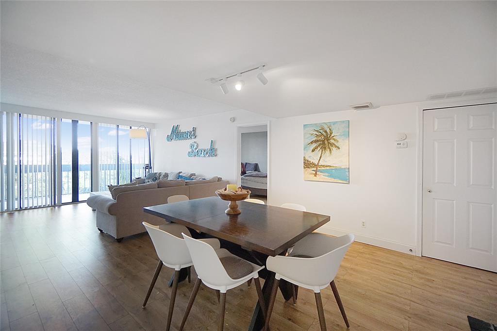 2400 Presidential Way, Unit 502 West Palm Beach, FL 33401 - Photo 9 of 28 a view of a dining room with furniture window and wooden floor
