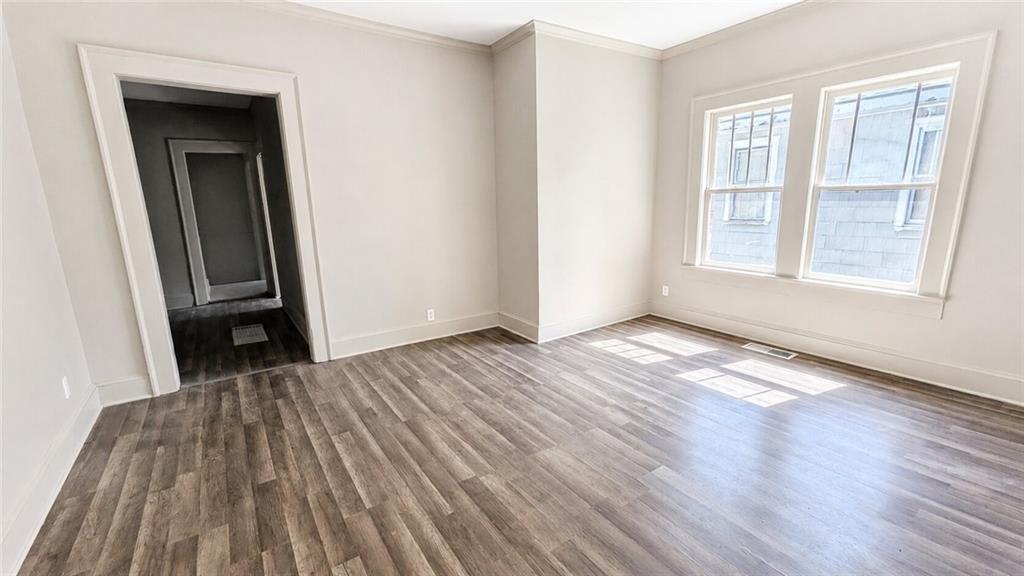 665 Lexington Avenue Southwest Atlanta, GA 30310 - Photo 18 of 33 an empty room with wooden floor and windows