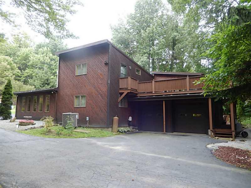 17 Spruce Peak Road Acme, PA 15610 - Photo 25 of 25 Exterior Back. View of the home from the side showing large driveway and decks off the back that wrap around the side