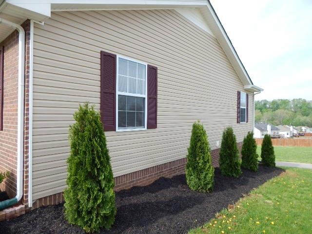 Right side of home with fresh landscaping. 
