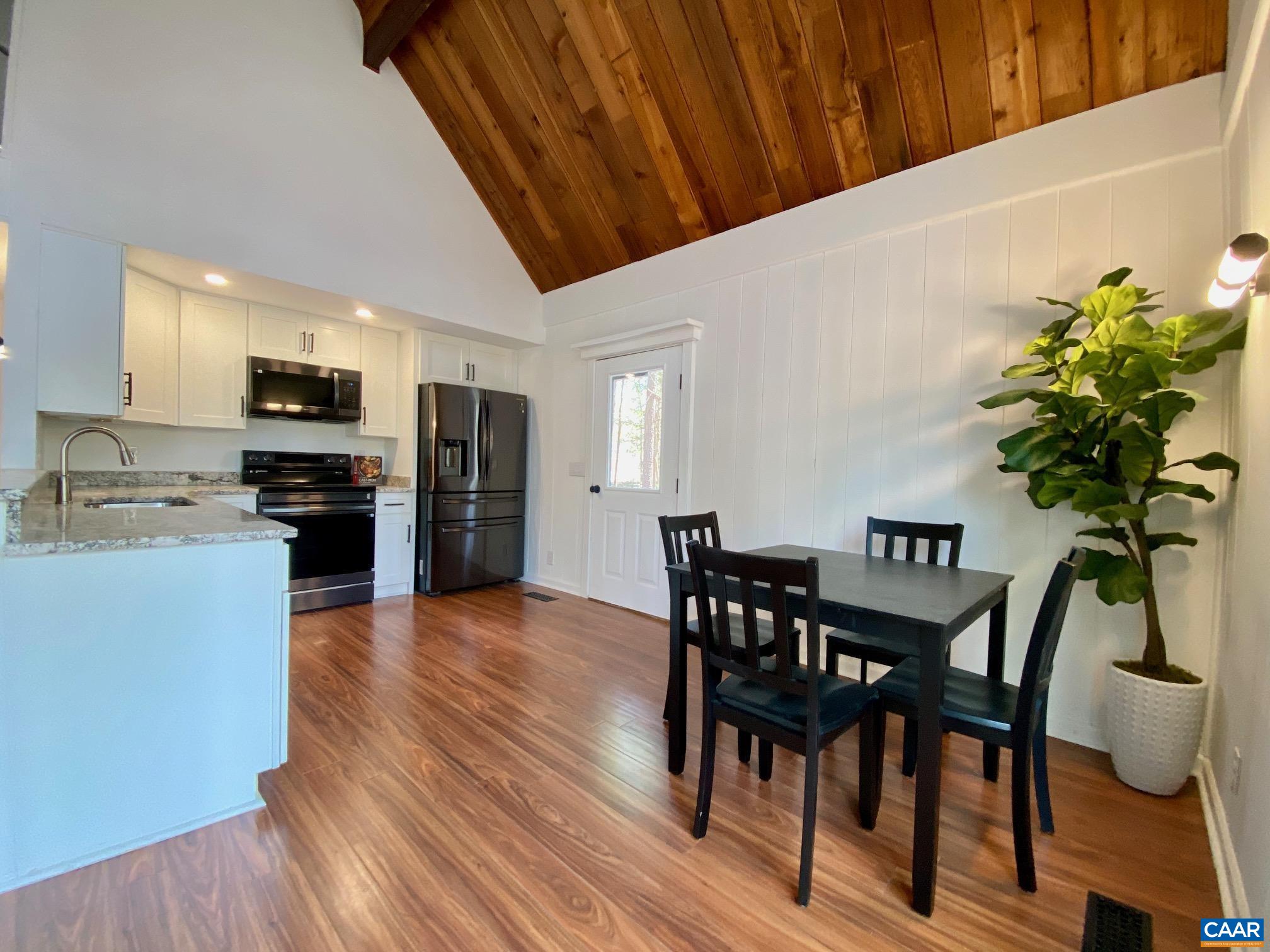 24 Tanglewood Road Palmyra, VA 22963 - Photo 8 of 23 a view of a dining room with furniture and a potted plant