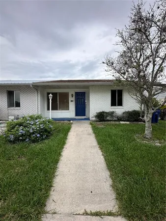 a front view of house with yard and green space