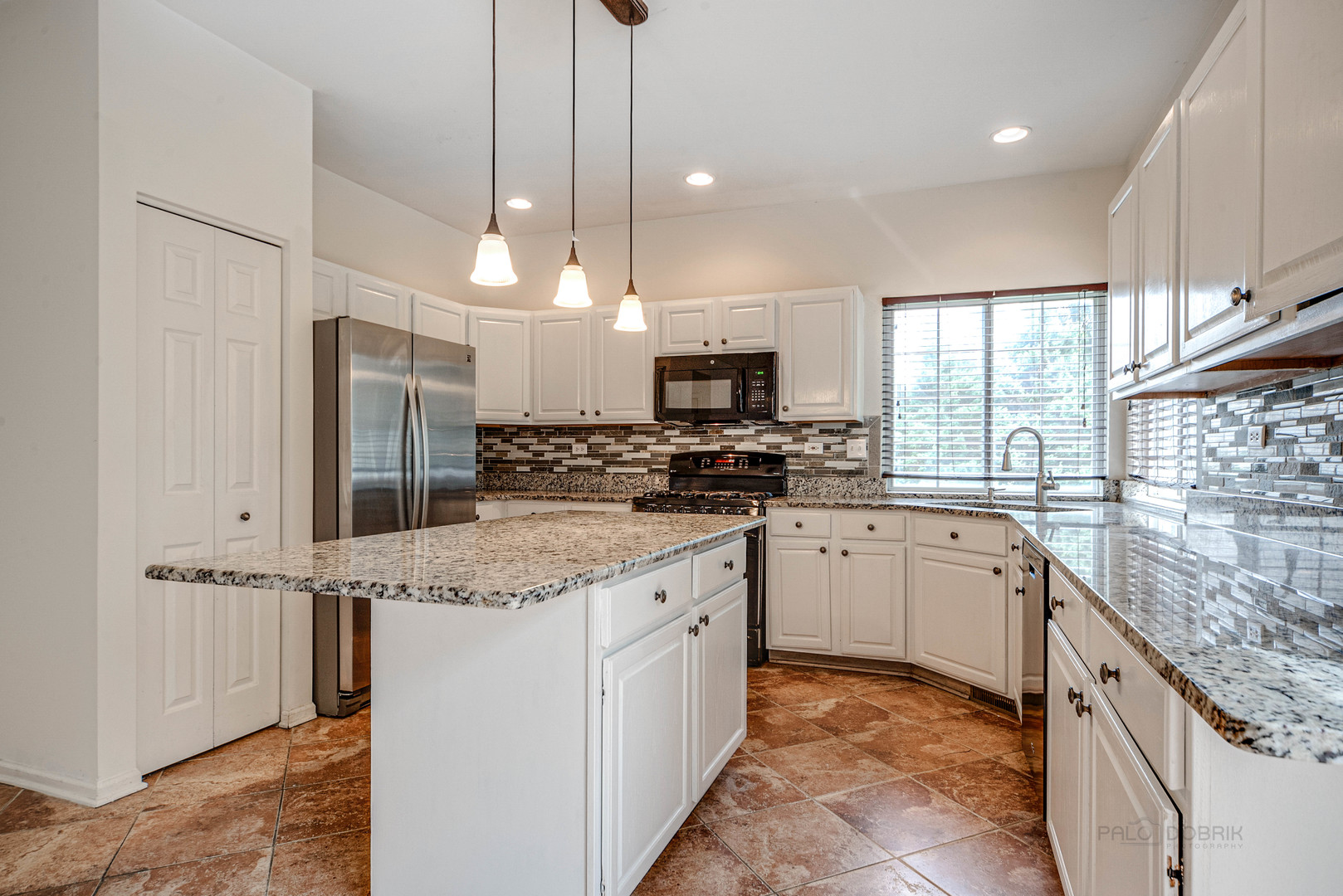 185 Aberdeen Drive Algonquin, IL 60102 - Photo 13 of 36 a kitchen with stainless steel appliances granite countertop a stove a sink and a refrigerator