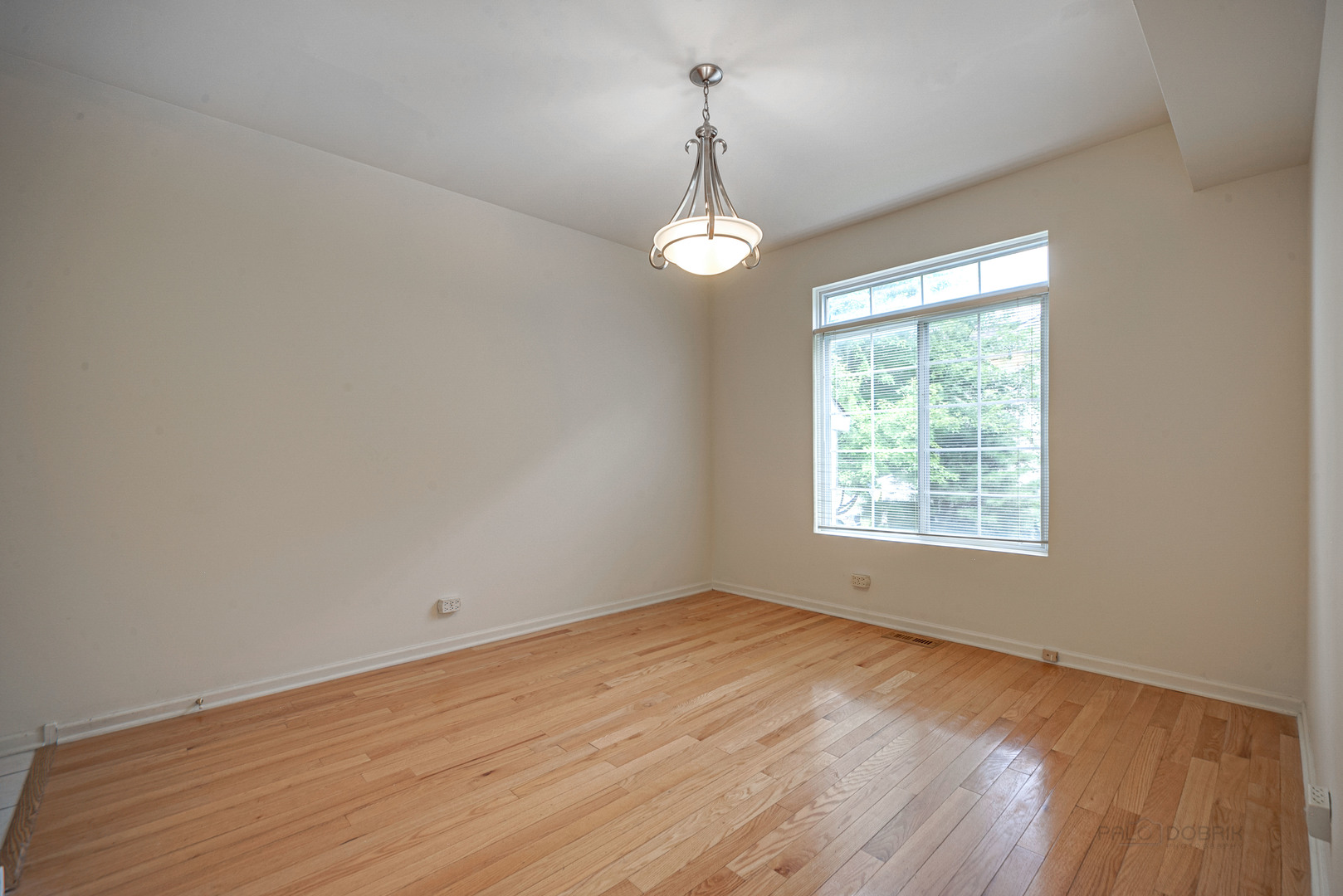 185 Aberdeen Drive Algonquin, IL 60102 - Photo 16 of 36 an empty room with wooden floor and windows
