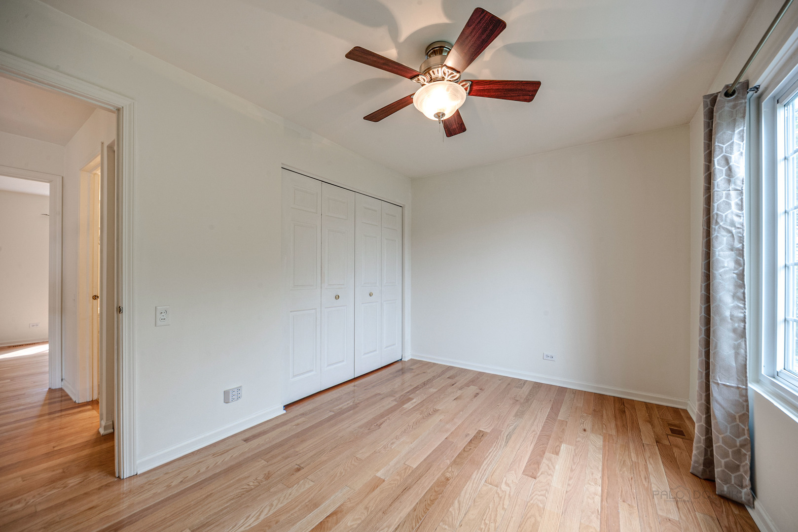185 Aberdeen Drive Algonquin, IL 60102 - Photo 19 of 36 an empty room with wooden floor fan and windows