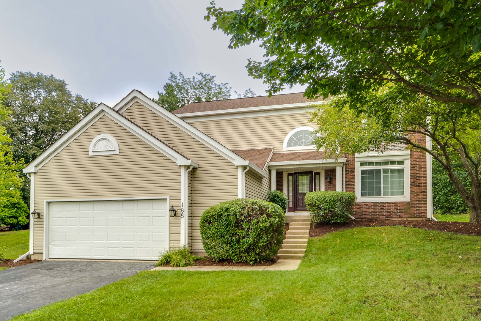 185 Aberdeen Drive Algonquin, IL 60102 - Photo 2 of 36 a front view of a house with a garden