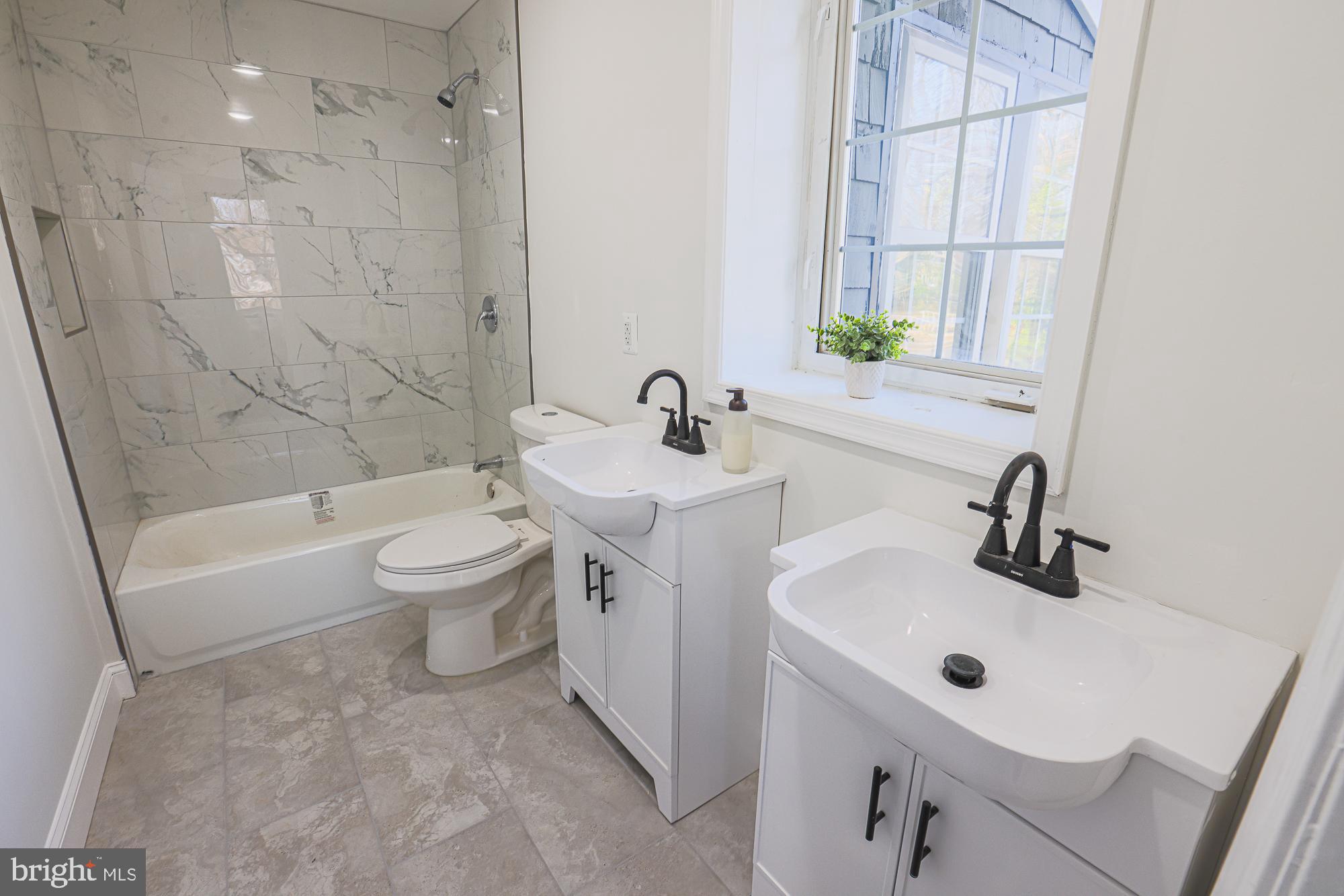 2606 Queen Anne Road Baltimore, MD 21216 - Photo 71 of 92 Elegant dual vanity in a modern bathroom.