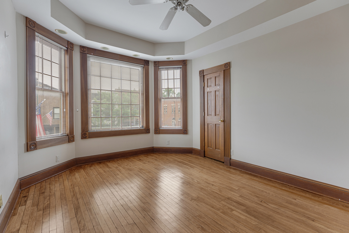 222 West Main Street, Unit A St. Charles, IL 60174 - Photo 14 of 17 an empty room with wooden floor chandelier and windows