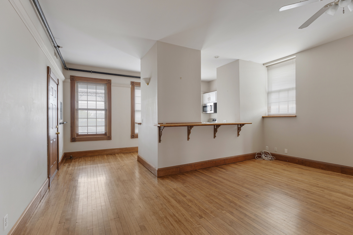 222 West Main Street, Unit A St. Charles, IL 60174 - Photo 5 of 17 wooden floor in an empty room with a window