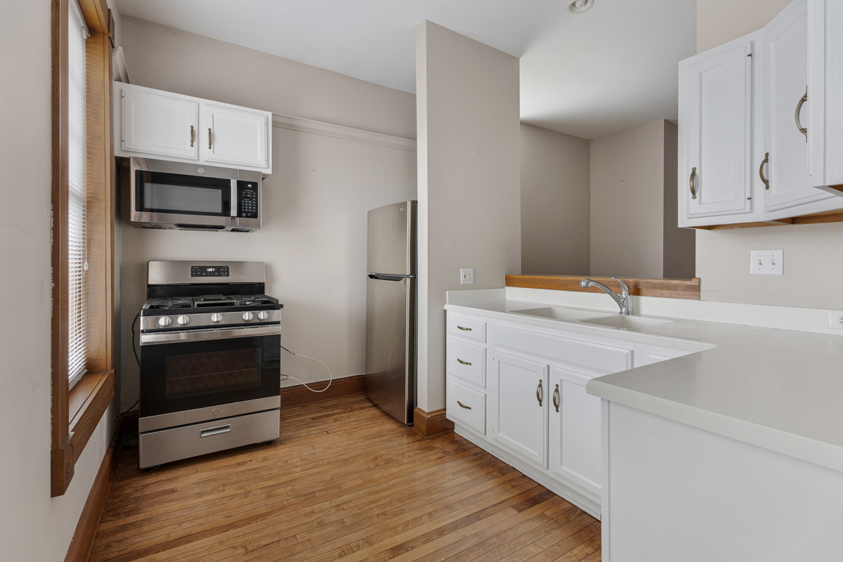 222 West Main Street, Unit A St. Charles, IL 60174 - Photo 7 of 17 a kitchen with stainless steel appliances white cabinets and a sink