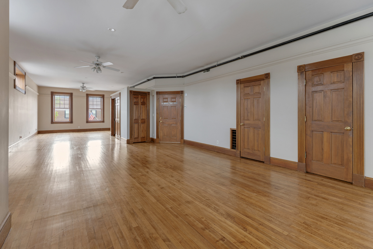 222 West Main Street, Unit A St. Charles, IL 60174 - Photo 9 of 17 a view of an empty room with wooden floor and windows