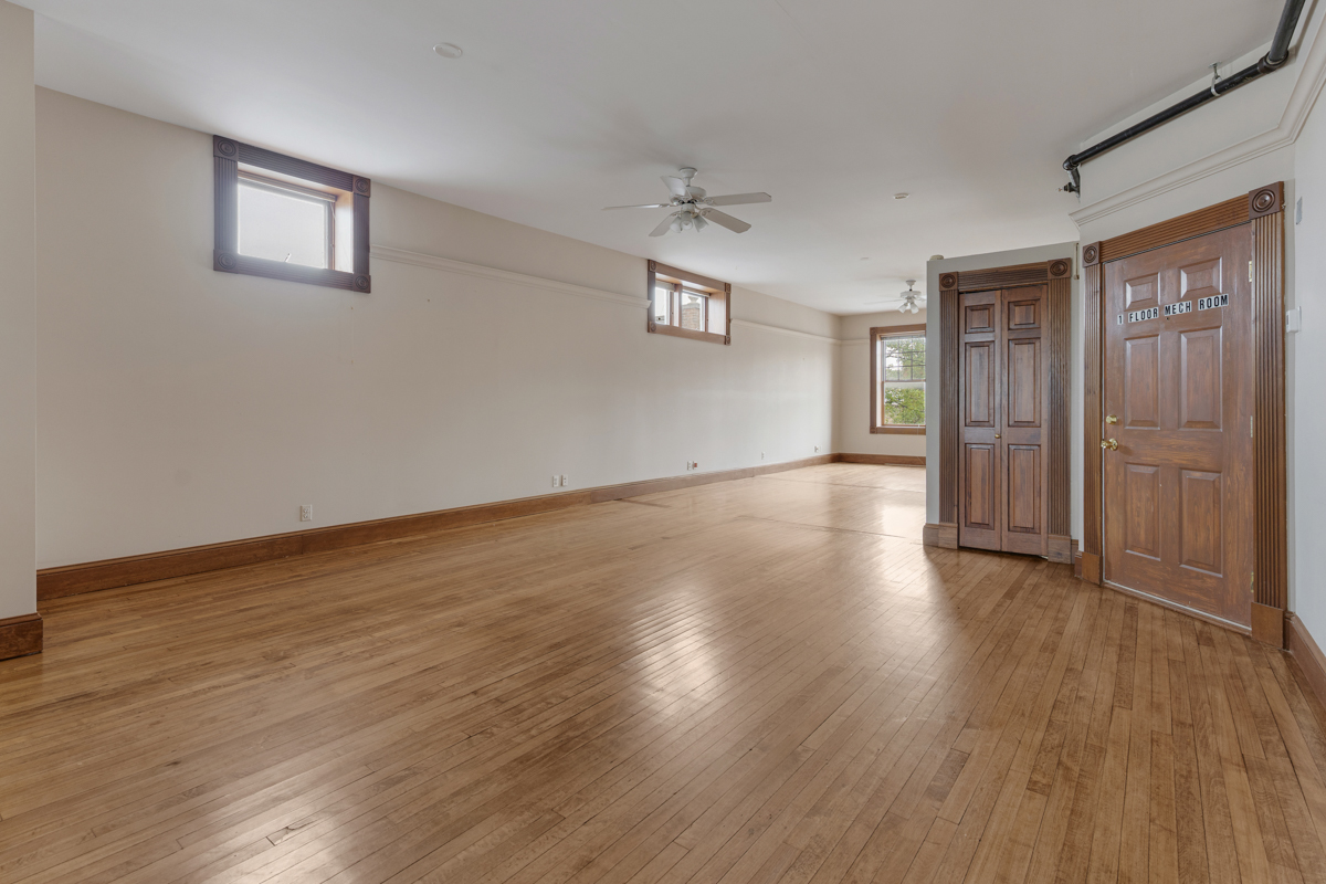 222 West Main Street, Unit A St. Charles, IL 60174 - Photo 10 of 17 an empty room with wooden floor and windows