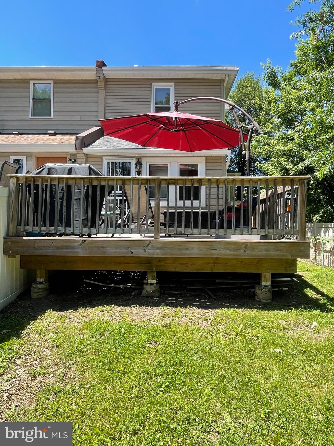 8129 Pine Road Philadelphia, PA 19111 - Photo 35 of 40 Sunny deck with vibrant red umbrella.