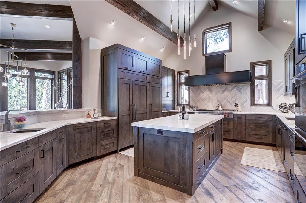 121 Boulder Circle Breckenridge, CO 80424 - Photo 13 of 35 a kitchen with stainless steel appliances granite countertop a sink a stove and a wooden floors