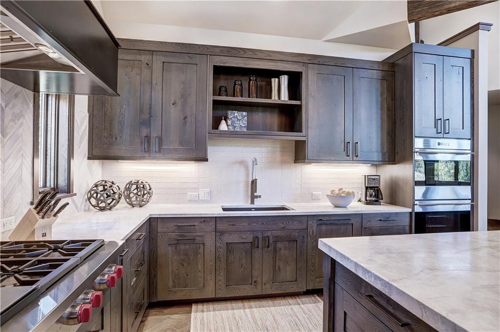 121 Boulder Circle Breckenridge, CO 80424 - Photo 14 of 35 a kitchen with stainless steel appliances granite countertop a sink stove and cabinets