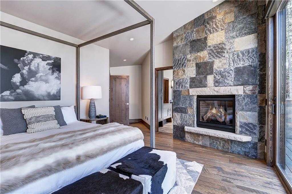 121 Boulder Circle Breckenridge, CO 80424 - Photo 17 of 35 a bedroom with a bed and a fireplace