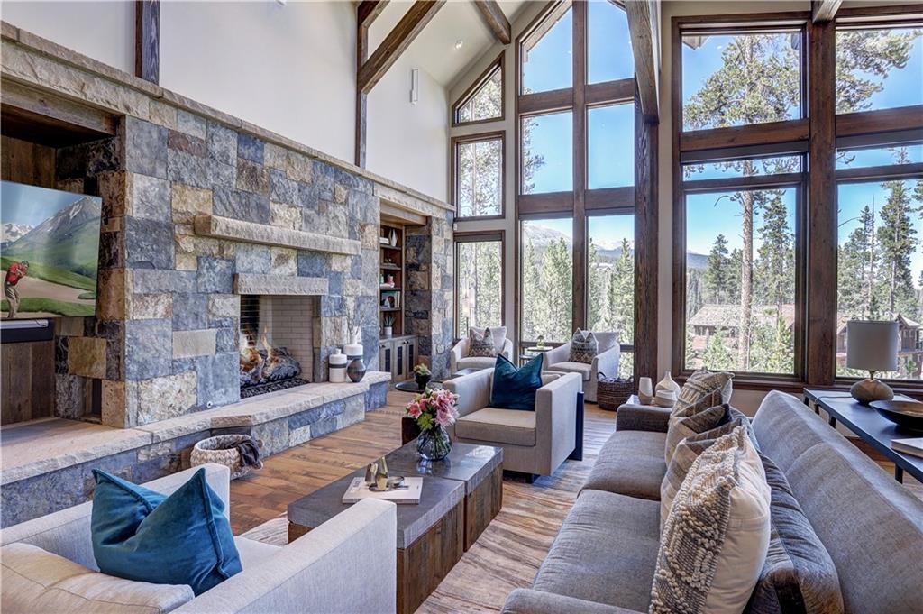 121 Boulder Circle Breckenridge, CO 80424 - Photo 5 of 35 a living room with furniture large windows and a fireplace