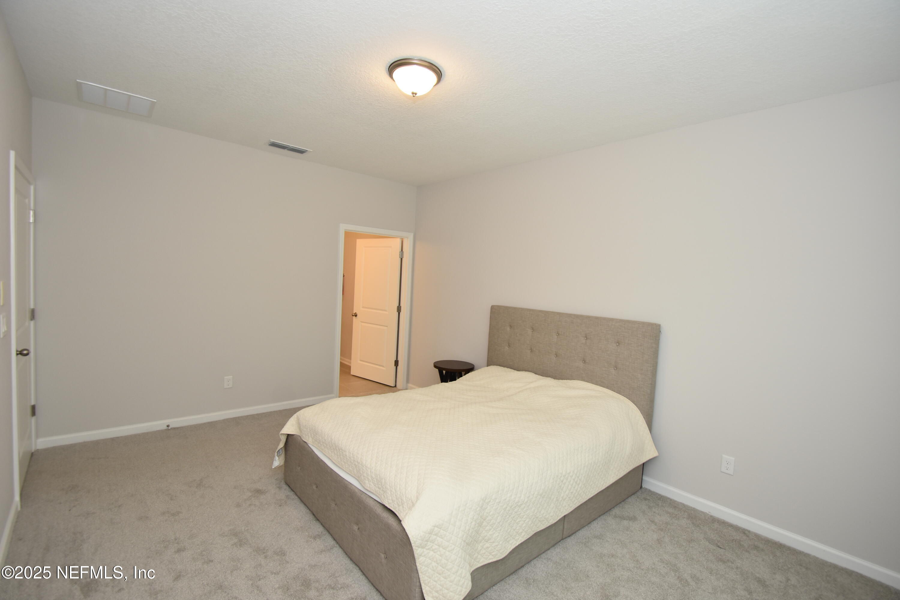 172 Charlie Way St. Augustine, FL 32095 - Photo 13 of 29 a bedroom with a bed and a window