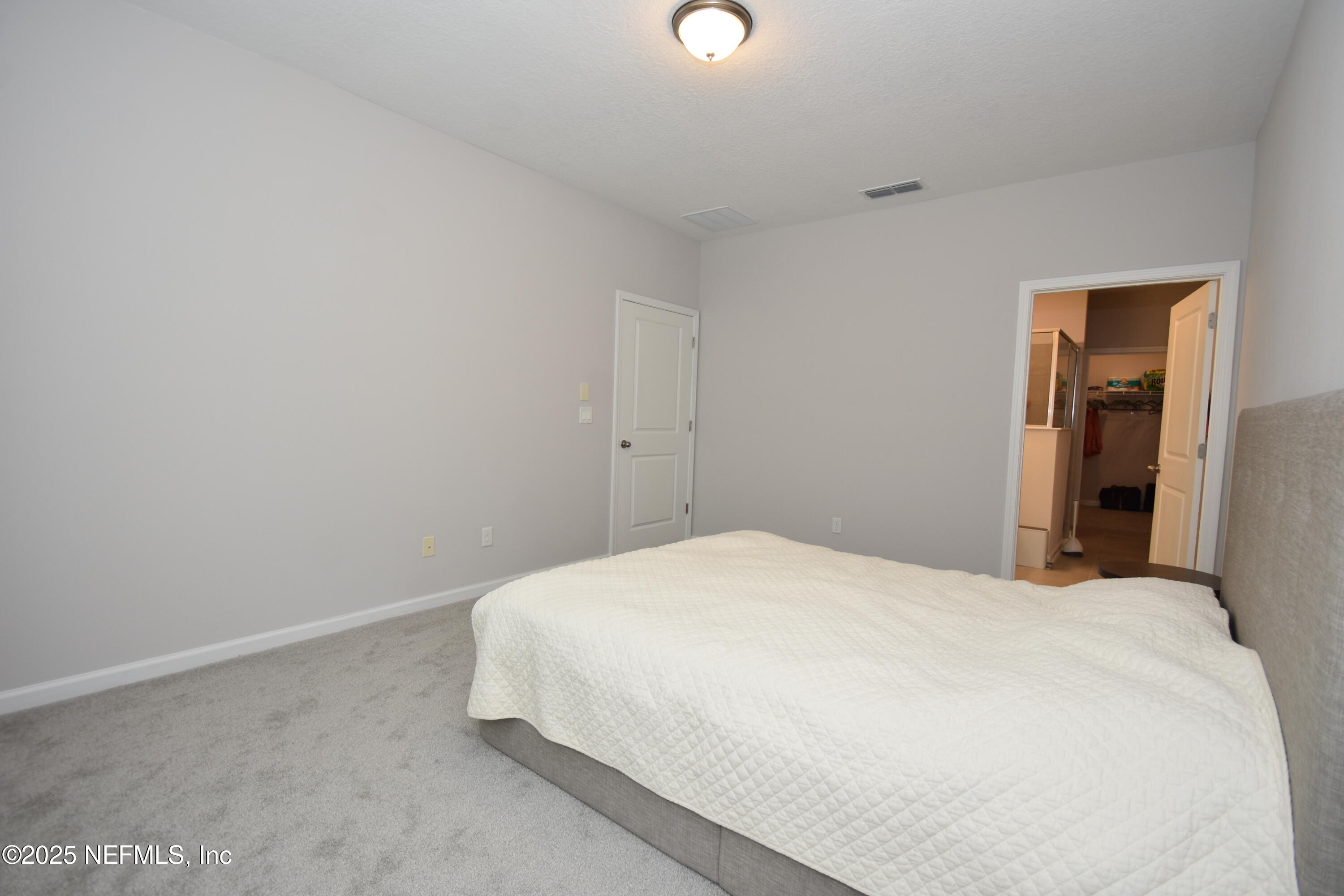 172 Charlie Way St. Augustine, FL 32095 - Photo 14 of 29 a bedroom with a bed and closet