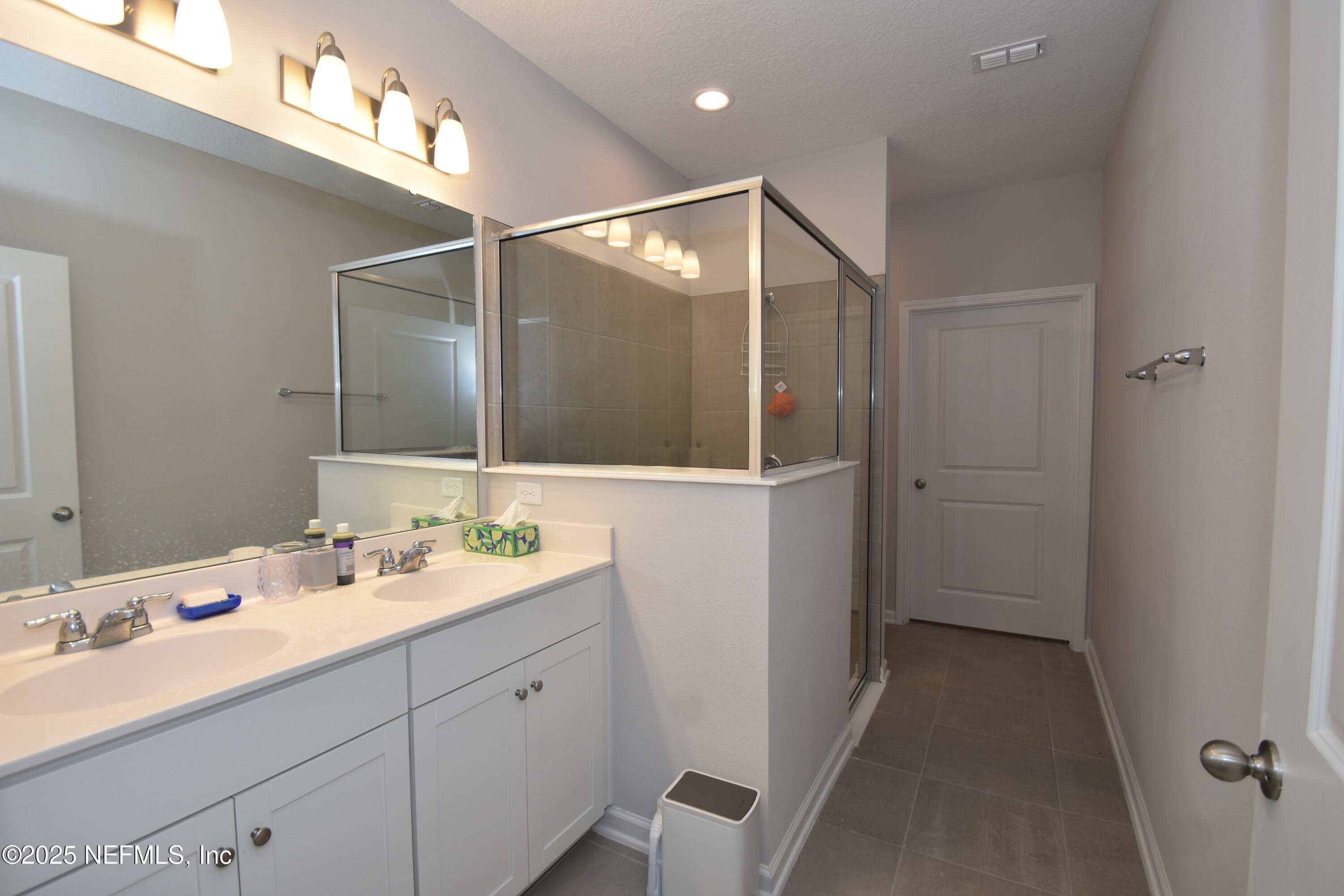 172 Charlie Way St. Augustine, FL 32095 - Photo 15 of 29 a bathroom with a sink and mirror