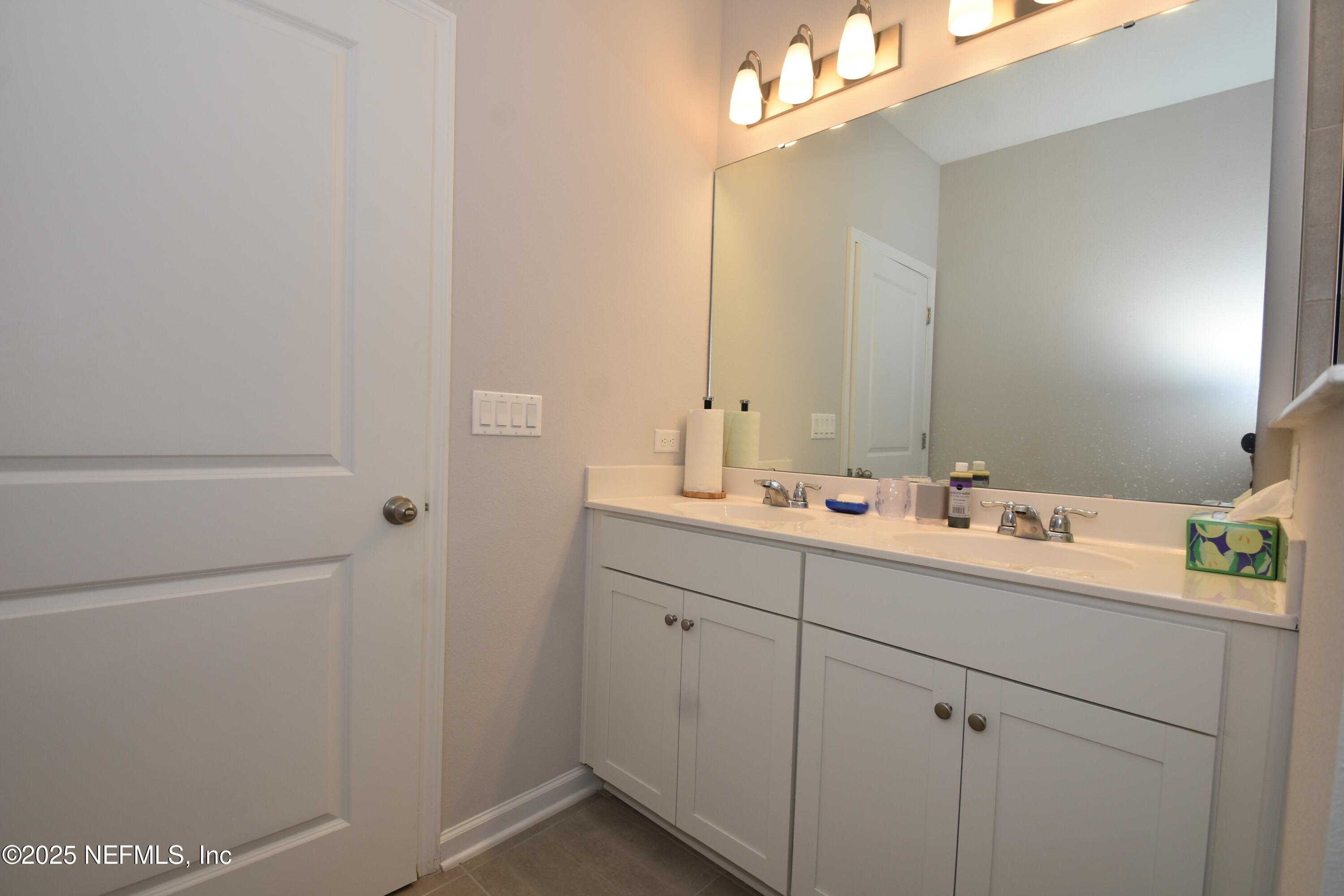 172 Charlie Way St. Augustine, FL 32095 - Photo 16 of 29 a bathroom with a sink and a mirror