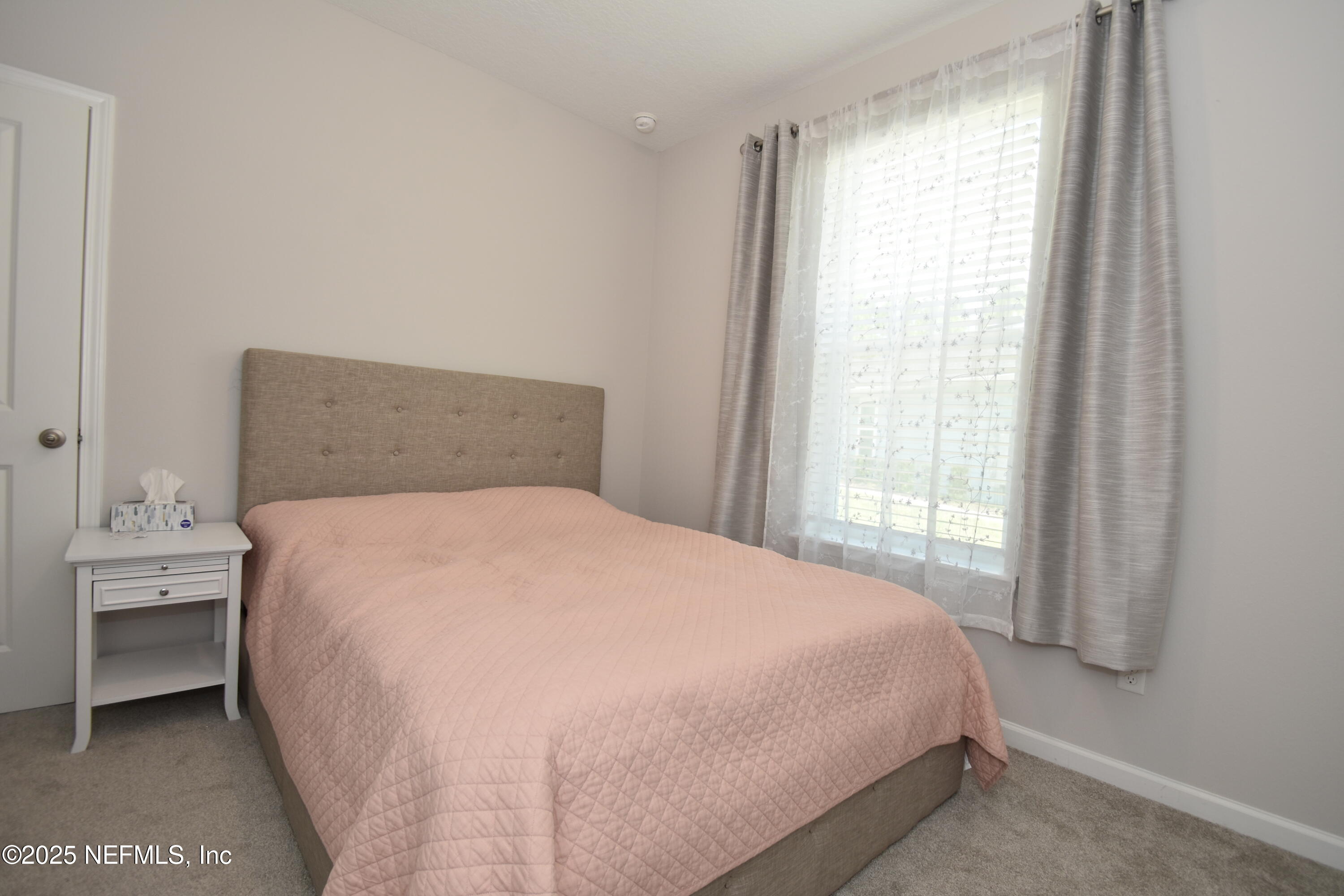 172 Charlie Way St. Augustine, FL 32095 - Photo 18 of 29 a large bed sitting in a bedroom next to a window