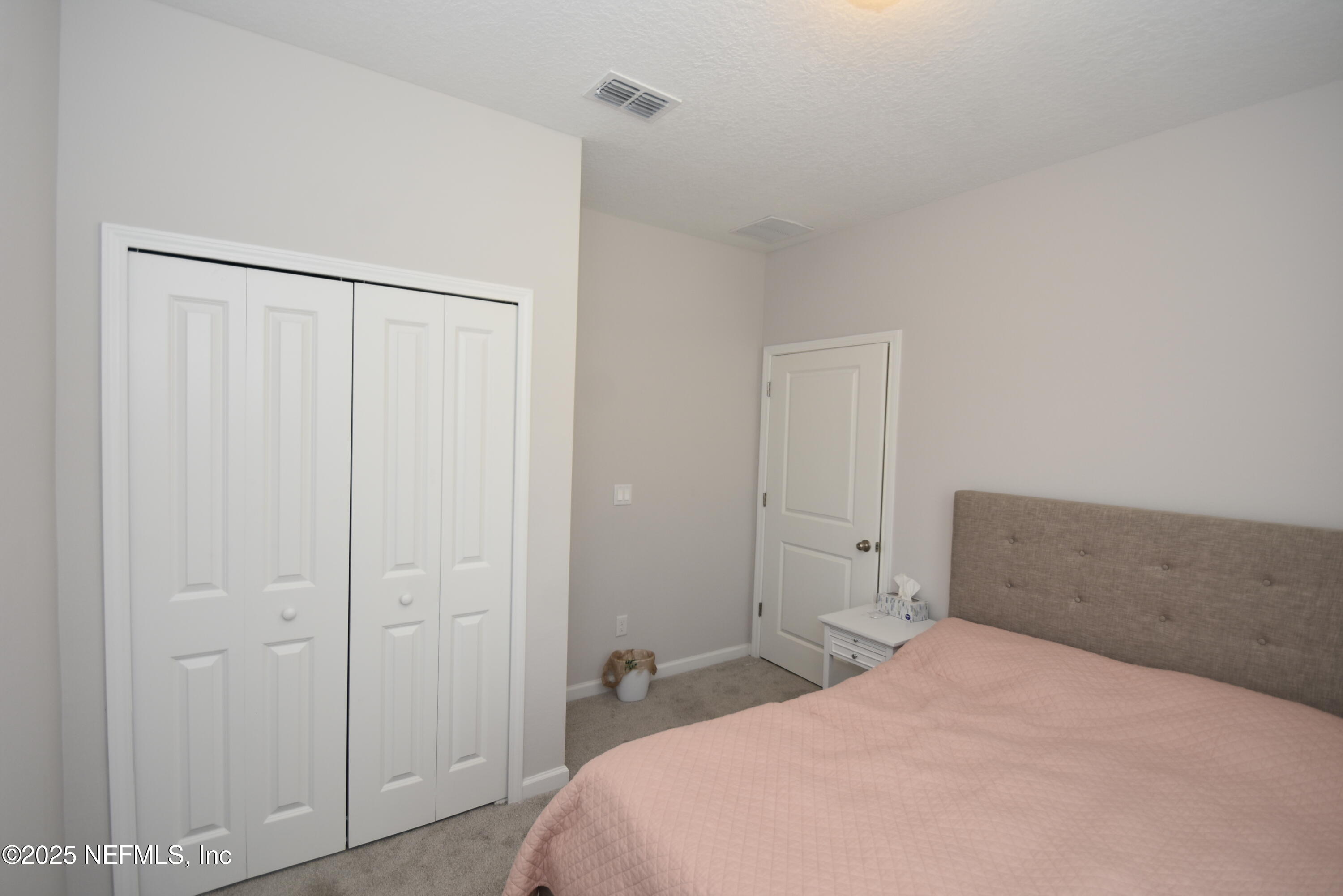 172 Charlie Way St. Augustine, FL 32095 - Photo 19 of 29 a bedroom with a bed and a closet