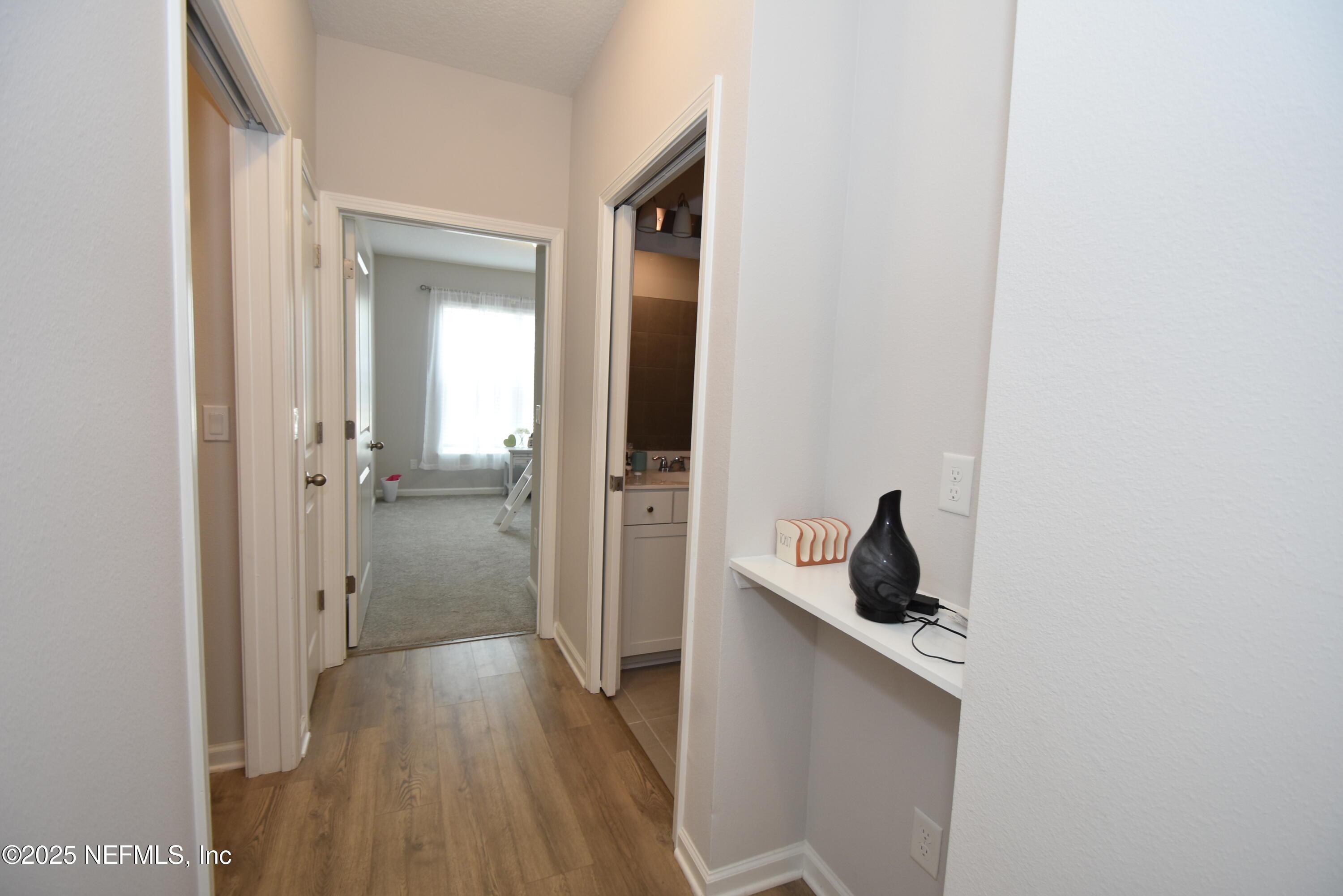 172 Charlie Way St. Augustine, FL 32095 - Photo 21 of 29 a view of a hallway with wooden floor and closet